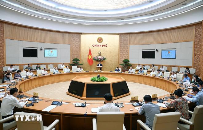 Toàn cảnh cuộc họp. (Ảnh: Dương Giang/TTXVN) ttxvn-thu-tuong-chu-tri-cuoc-hop-thao-go-vuong-mac-chinh-quyen-dia-phuong-hai-cap4.jpg